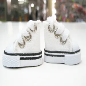 Detailed macro view showing the side texture of 3.5cm mini white canvas doll shoes