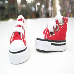 Macro detail view of 3.5cm miniature red canvas sneakers for doll accessories or keychains