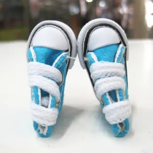 Macro view of 3.5cm miniature blue canvas shoes for dolls or keychain charms