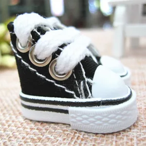 Detailed macro view of 3.5cm mini black canvas sneakers for doll accessories and keychains