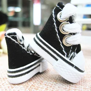 Close-up macro detail of 3.5cm mini black canvas sneakers for doll accessories