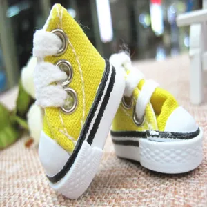 Macro view of 3.5cm miniature yellow canvas shoes for doll accessories or keychains