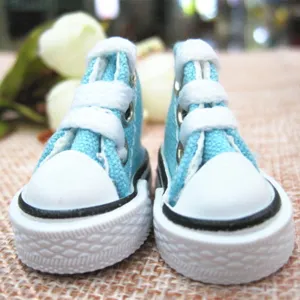 Detailed close-up of 3.5cm light blue miniature canvas sneakers for dolls and crafts.