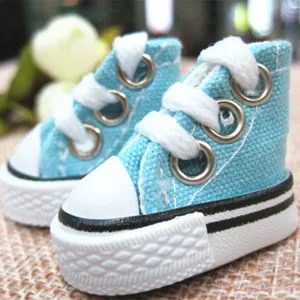 Macro view of mini 3.5cm light blue canvas shoes for dolls with detailed white laces