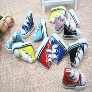 Macro view of colorful 3.5cm mini canvas shoes for dolls and keychains