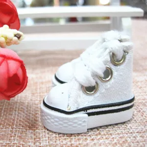 Close-up of 3.5cm white miniature canvas high-top sneakers for dolls accessories.