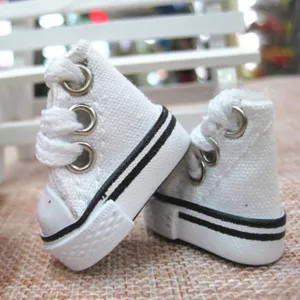 Detail view of 3.5cm white miniature canvas high-top sneakers for Barbie and BJD dolls.