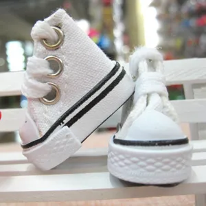 Close-up of 3.5cm miniature white canvas shoes for dolls and keychains
