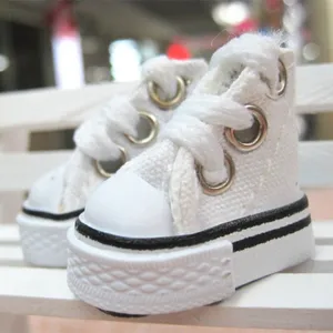 Macro shot of 3.5cm mini white canvas doll sneakers for craft and doll accessories