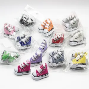 Detailed view of various colorful 3.5cm miniature doll canvas sneakers in plastic packaging