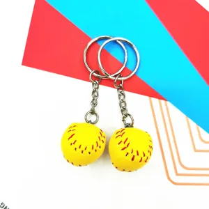Close-up of two mini yellow baseball keychains with realistic red stitching details.