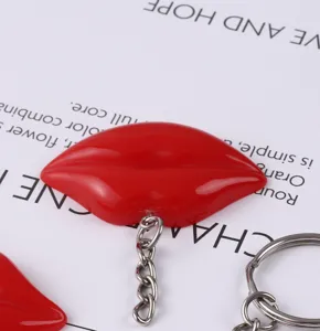 Macro view of the glossy red resin lip pendant on a high-quality silver-tone keychain