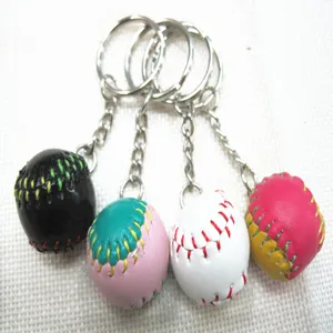 Detail view of four colorful 2cm mini baseball keychains featuring realistic stitching