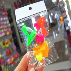 Detailed view of 2.5cm colorful mini puzzle keychain toy in transparent retail packaging