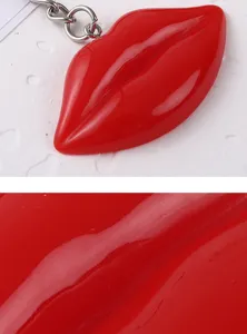 Close-up detail of glossy red resin lip keychain pendant showing smooth texture finish