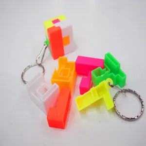 Detail view of disassembled 2.5cm puzzle cube keychain showing colorful plastic blocks.
