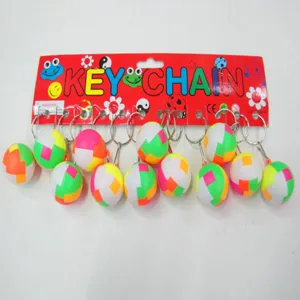 Detail view of colorful 2.5cm puzzle ball keychains on red display cardboard