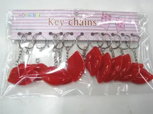 Detail view of ten red resin lip keychains in their clear plastic retail packaging