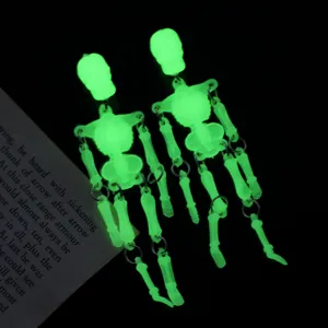 Toma detallada macro que muestra el brillo verde luminoso de los pendientes de esqueleto Halloween
