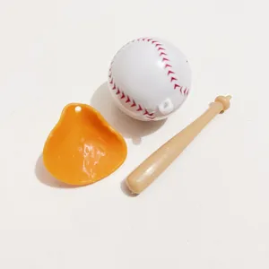 Close-up detail of miniature plastic baseball, orange glove, and bat for sports keychains