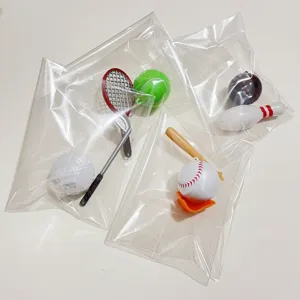 Detail view of miniature sports keychains including tennis, golf and baseball sets