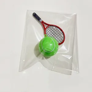Detailed close-up of mini tennis racket and ball set inside a clear plastic bag