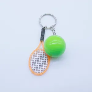 Macro shot of a creative mini tennis racket and green ball sports keychain pendant.