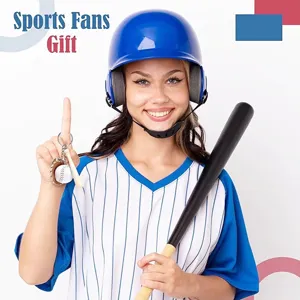 Model in a baseball helmet holding a miniature sports keychain with a mini bat