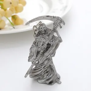 Close-up of a detailed Grim Reaper keychain holding a scythe for Halloween gift.