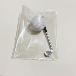 Detailed view of miniature golf ball and club keychain in clear plastic packaging