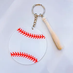 Macro view of acrylic baseball keychain pendant featuring a miniature wooden bat charm.