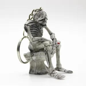 Detailed view of the resin skeleton sitting on a toilet keychain for Halloween gift