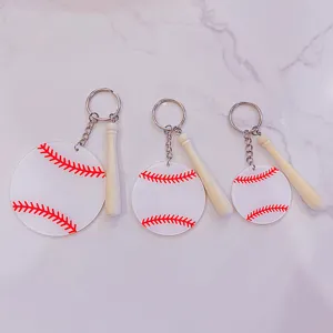 Close-up detail of three acrylic baseball keychains in different sizes with mini wooden bats