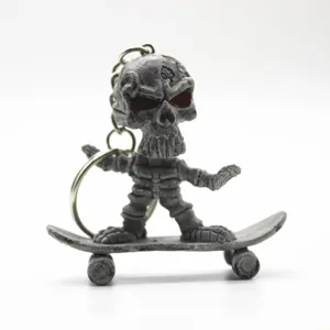 Detailed view of skull keychain figure on a grey skateboard for Halloween gift