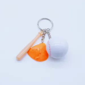 Macro shot of sports themed keychain featuring mini baseball bat, glove, and white ball