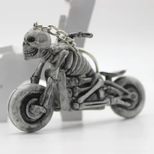 Close-up detail of a gothic skeleton rider on a motorcycle keychain for Halloween gifts