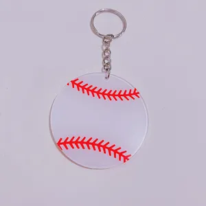 Macro view of acrylic baseball keychain with red stitching on a frosted white disc