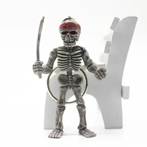Close-up detail of a Halloween skeleton warrior keychain with a sword and red headband