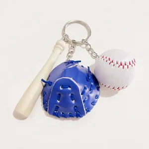 Detail showing a mini wooden bat, blue glove, and white baseball charms on a keychain.