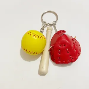 Detailed view of baseball keychain with miniature bat, red glove, and yellow ball charms