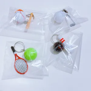 Set of four mini sports ball keychains including tennis, golf, and baseball.