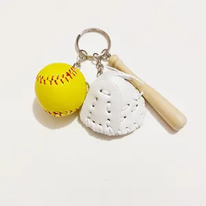 Close-up of baseball keychain set with yellow ball, white glove, and wooden bat