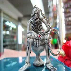 Detailed close-up of a funny Halloween skeleton sitting on a toilet keychain pendant