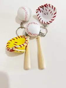 Detailed view of mini baseball glove and wooden bat keychain accessories for bags