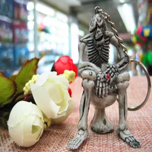 Detailed view of a creative skeleton sitting on a toilet keychain for Halloween gifts