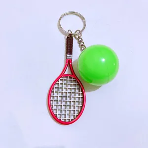 Close-up detail of a creative mini tennis racket and green ball sports keychain