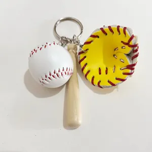 Detailed view of the sports keychain set featuring a mini baseball, bat, and yellow glove.