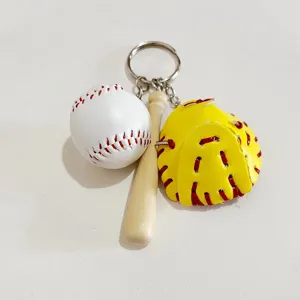 Detailed view of sports baseball keychain with white ball, wooden bat, and yellow mitt.