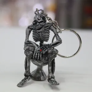 Detailed view of a creative Halloween skeleton sitting on a toilet keychain charm