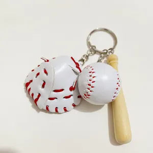 Detailed view of baseball keychain with white glove, ball, and wooden bat accessory.